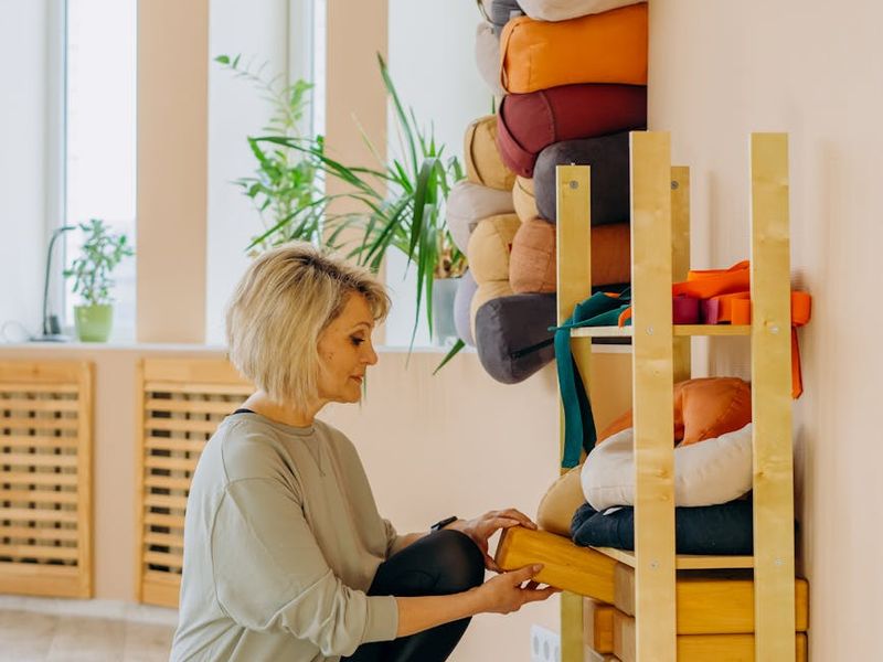Minimalist yoga studio with natural wood floors and warm light.